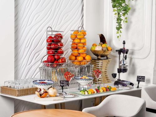 a table with a display of fruit on it at Mövenpick Samarkand in Samarkand