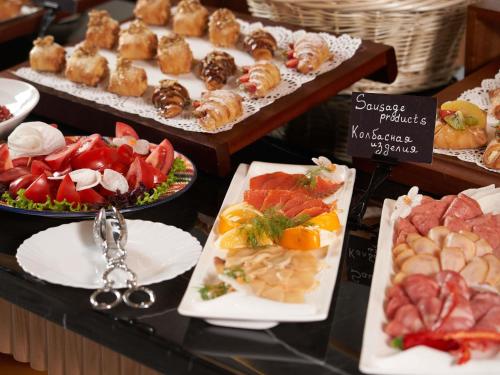a buffet of different types of food on plates at Mövenpick Samarkand in Samarkand