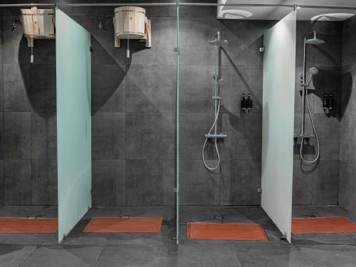 a bathroom with a shower with a glass door at Mövenpick Samarkand in Samarkand