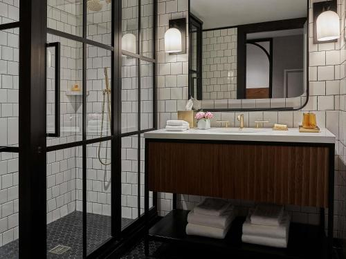 a bathroom with a sink and a mirror at 21c Museum Hotel St Louis in Saint Louis
