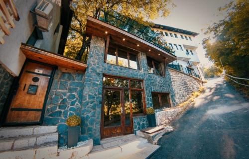 a building with a blue stone facade with a window at Guest House LIKE in Sarajevo