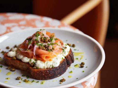 a white plate with a sandwich on a piece of bread at 21c Museum Hotel St Louis in Saint Louis