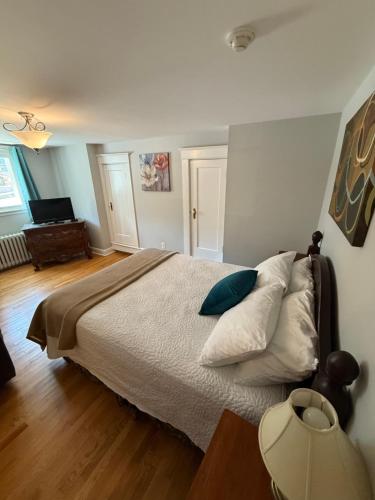 a bedroom with a bed with pillows on it at Midstream Manor Unit 3, Studio in St. John's
