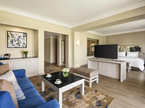 a living room with a couch and a bed at Rixos Sharm El Sheikh - Adults Only 18 Plus in Sharm El Sheikh