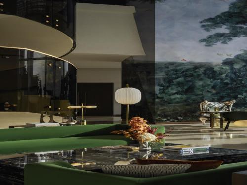 a living room with a table with a vase of flowers at SO/ Uptown Dubai in Dubai