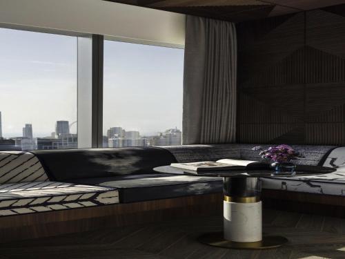 a room with a couch and a table and a window at SO/ Uptown Dubai in Dubai