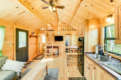 a kitchen and living room of a wooden cabin at 5 Mi to Susquehanna Boating! Secluded Log Cabin in Shamokin Dam