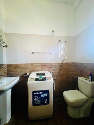 a bathroom with a toilet and a sink at Ohana Beach in Tangalle