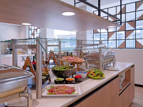 a buffet line with many different types of food at Fora Hotel Hannover by Mercure in Hannover