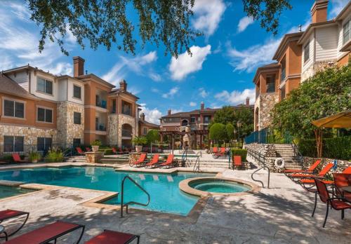 a swimming pool with chairs and a building at South Congress Austin Modern 2BR with Pool, Hot Tub, Convenient to Nightlife in Austin