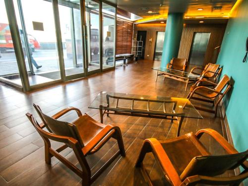 a group of chairs and tables in a room at Novotel Puerto Montt in Puerto Montt