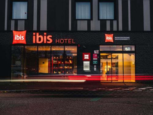 a store front of aoks hotel on a city street at Ibis Rouen Centre Rive Gauche Mermoz in Rouen