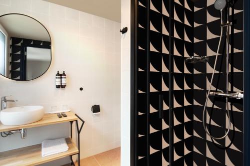 a bathroom with a sink and a mirror at Hotel Zeedijk City Centre in Amsterdam