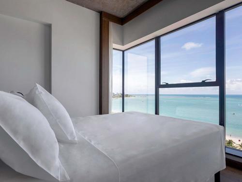 Una cama o camas en una habitación de ibis Styles Maceió Pajuçara