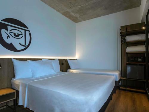 Una cama o camas en una habitación de ibis Styles Maceió Pajuçara