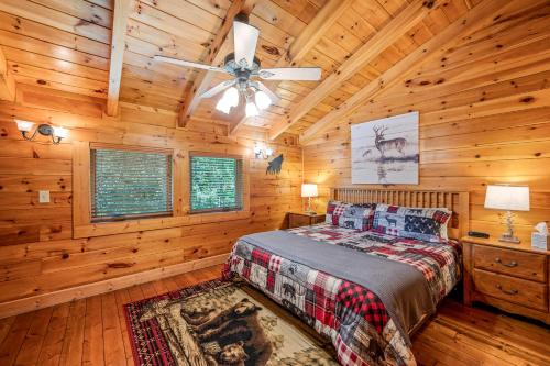 a bedroom with a bed and a ceiling fan at Sevierville Cabin with Deck Minutes to Pigeon Forge in Sevierville
