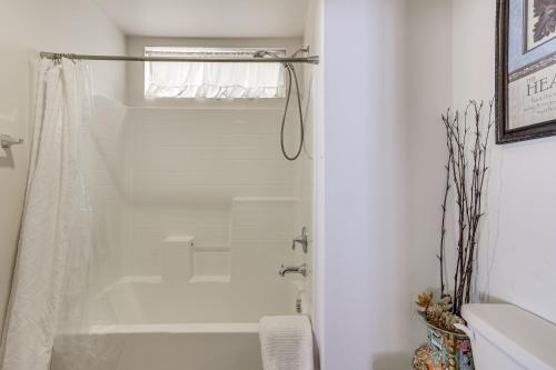 a white bathroom with a shower and a tub at Large Menifee Home 1 Block to Neighborhood Park! in Menifee