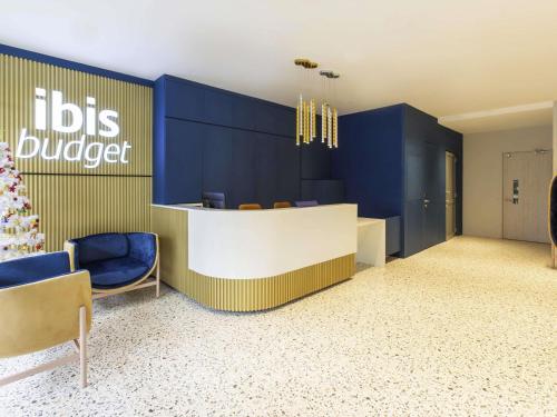 a dental office with blue walls and blue chairs at ibis budget Singapore Gold in Singapore