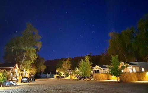 a parking lot at night with houses and trees at La Sal Vista Cabin #08 in Moab