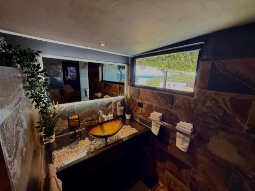 a bathroom with a sink and a large window at Sosua Inn Hotel in Sosúa