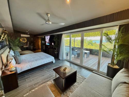 a bedroom with a bed and a view of the ocean at Sosua Inn Hotel in Sosúa