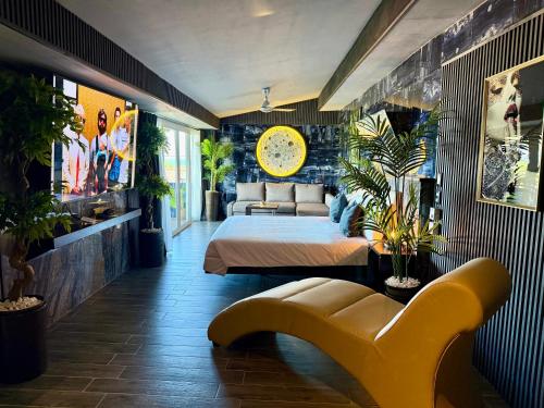 a bedroom with a bed and a couch in it at Sosua Inn Hotel in Sosúa