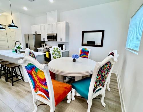 a kitchen and dining room with a table and chairs at Colorful Dining Experience in Cozy Getaway in Houston