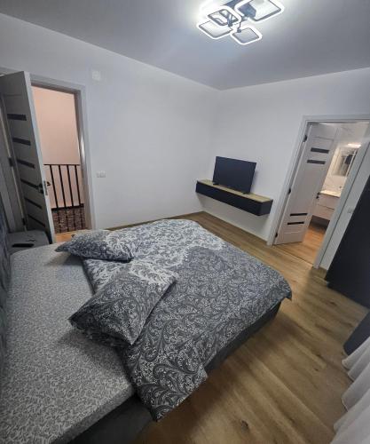 a bedroom with a large bed and a closet at IUNIk in Azuga