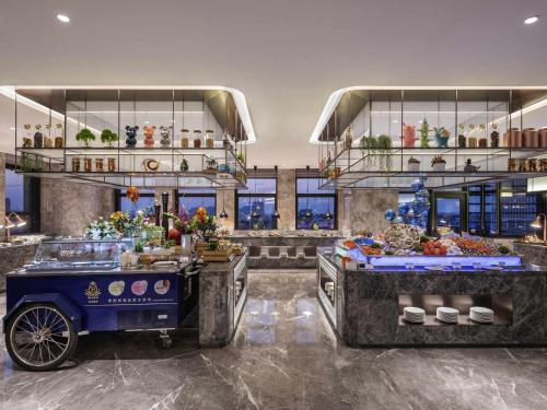 a restaurant with a buffet in the middle of a room at Novotel Kunshan Yangcheng Lake in Kunshan