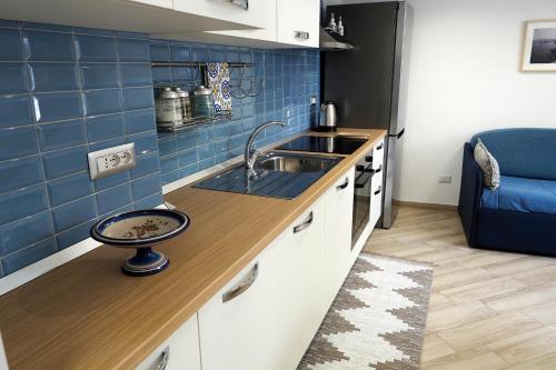 a small kitchen with a sink and a counter at San Francesco in Cetara
