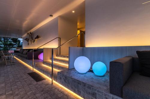 a lobby with blue and white spheres next to a staircase at Shama Yen-Akat Bangkok in Bangkok