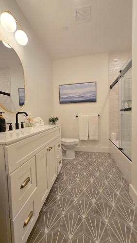 a white bathroom with a sink and a toilet at 2BR Apt with Parking Garden View Walk to Waterfront in Providence