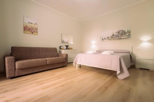 a bedroom with a bed and a couch at The Best Bed & Breakfast in Amantea