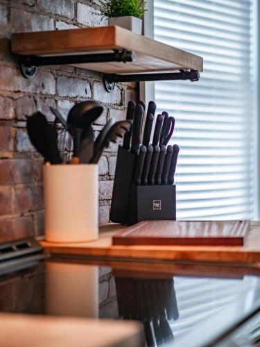 a table with a knife holder on a counter at Stunning Boho Apt in Ohio City in Cleveland