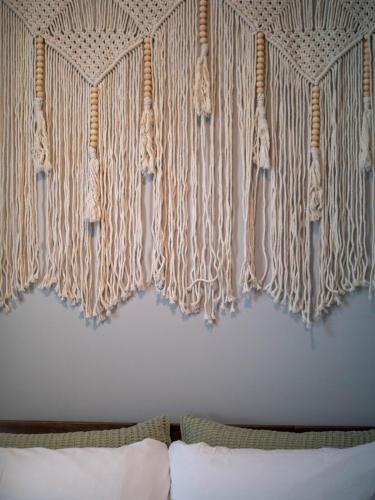 a curtain above a bed in a bedroom at Stunning Boho Apt in Ohio City in Cleveland