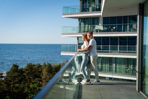una coppia sul balcone di un edificio di The SKY by Wave Międzyzdroje Resort&SPA a Międzyzdroje