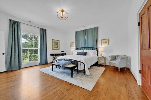 a bedroom with a bed and a chair and a window at Eighty Oaks, Jacksonville, AL in Jacksonville