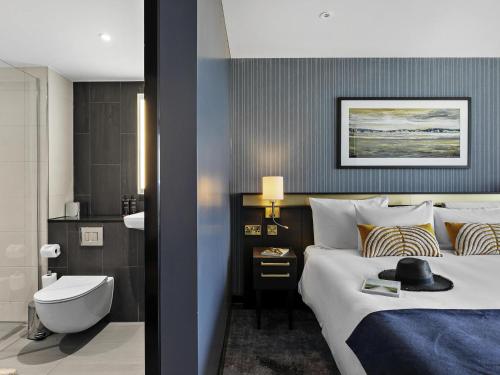 a hotel room with a bed and a bathroom at Mercure Paignton Hotel in Paignton