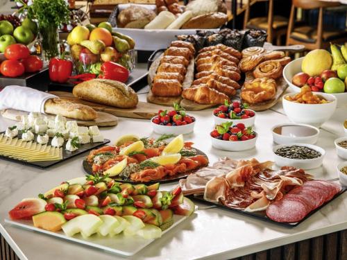 a table filled with lots of different types of food at Mercure Paignton Hotel in Paignton