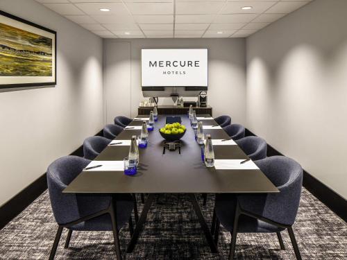 a conference room with a long table and chairs at Mercure Paignton Hotel in Paignton