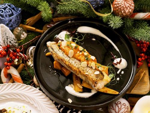 a black plate of food with fish and french fries at Mercure Singapore Tyrwhitt in Singapore