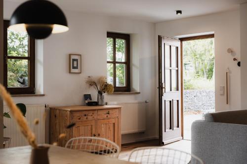 a living room with a table and a door at HØV - Boutique-Apartments im Allgäu - Rückzug & Design in Altusried