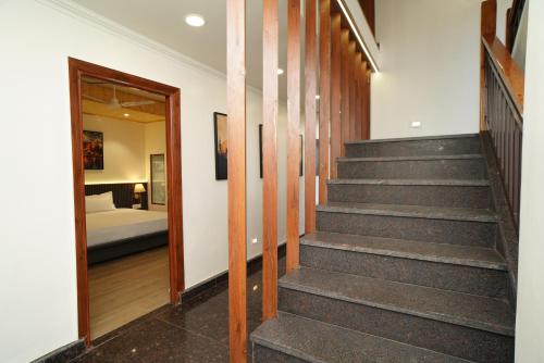 a staircase in a house with a bedroom at Hotel Premjees Paradise in Solan