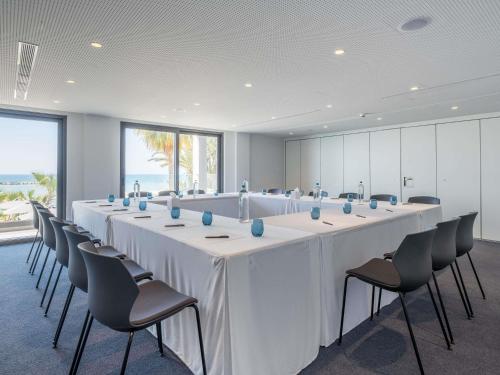 a large conference room with a long table and chairs at Mercure Larnaca Beach Resort in Larnaka