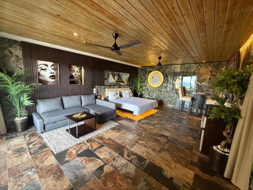 a living room with a couch and a bed at Sosua Inn Hotel in Sosúa