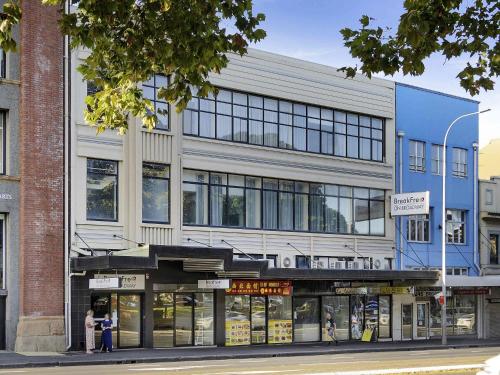 a building on a city street with people standing outside at BreakFree on Broadway Sydney, an Accor Hotel in Sydney
