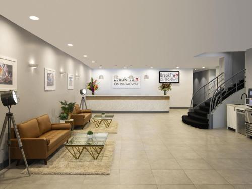 a lobby of a dental hospital with couches and stairs at BreakFree on Broadway Sydney, an Accor Hotel in Sydney