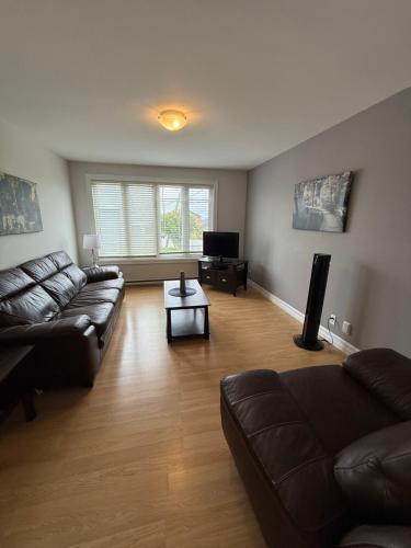 a living room with a couch and a table at Airport Manor Unit 3, 2 Bedroom Apartment in Torbay