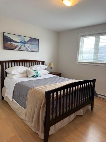 a bedroom with a large bed and a window at Airport Manor Unit 3, 2 Bedroom Apartment in Torbay