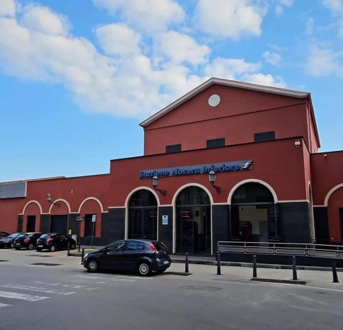 a red building with a car parked in front of it at Nocera House in Nocera Inferiore